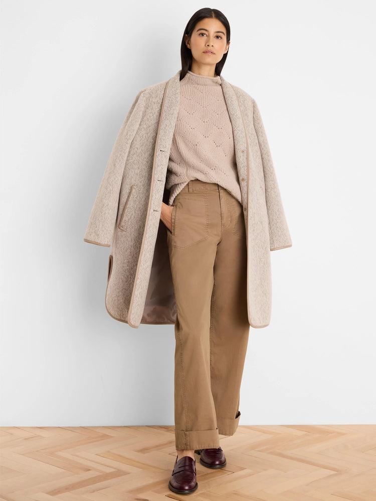 Light beige mock neck sweater with subtle diamond knit pattern.