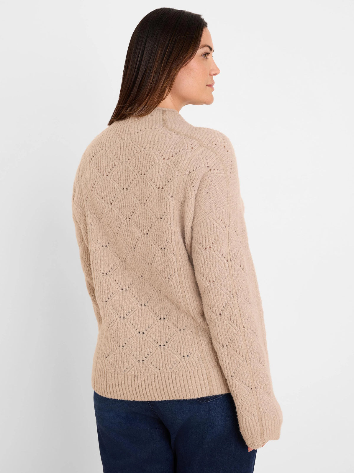 Light beige knit sweater with diamond pattern, ribbed mock neck, cuffs, and hem.