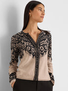 Beige cardigan with black lace print on the upper body and sleeves. V-neck, button-front.