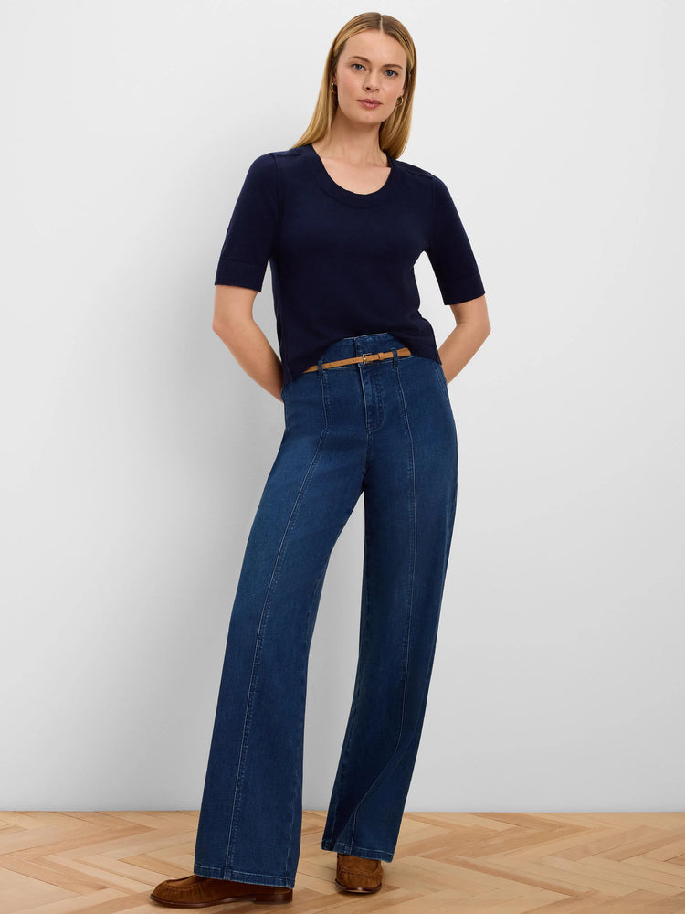 Navy pure cotton sweater tee with short sleeves, a round neck, and stitched shoulder details, worn by a woman.