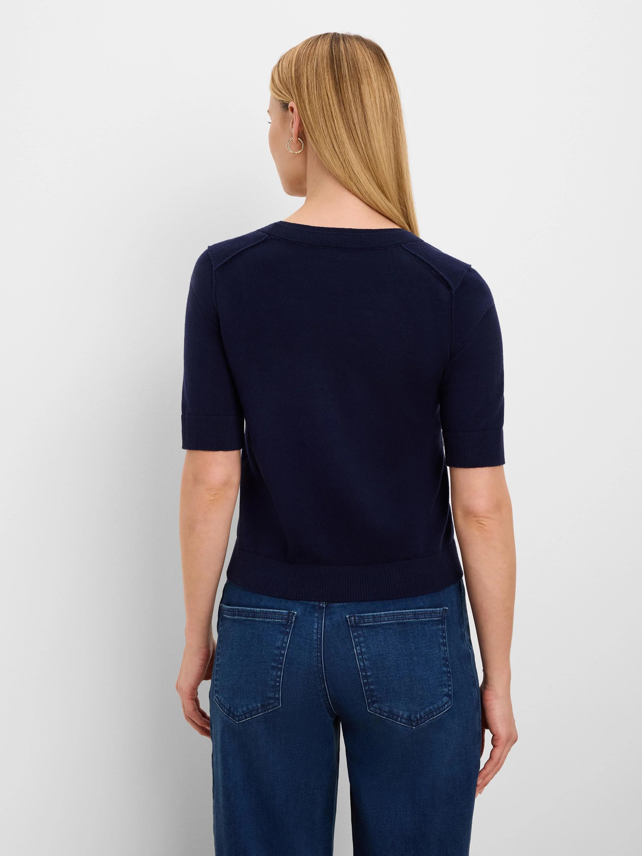 Navy short-sleeve sweater tee, back view. Features ribbed crew neck, sleeve cuffs, hem, and shoulder seam details.