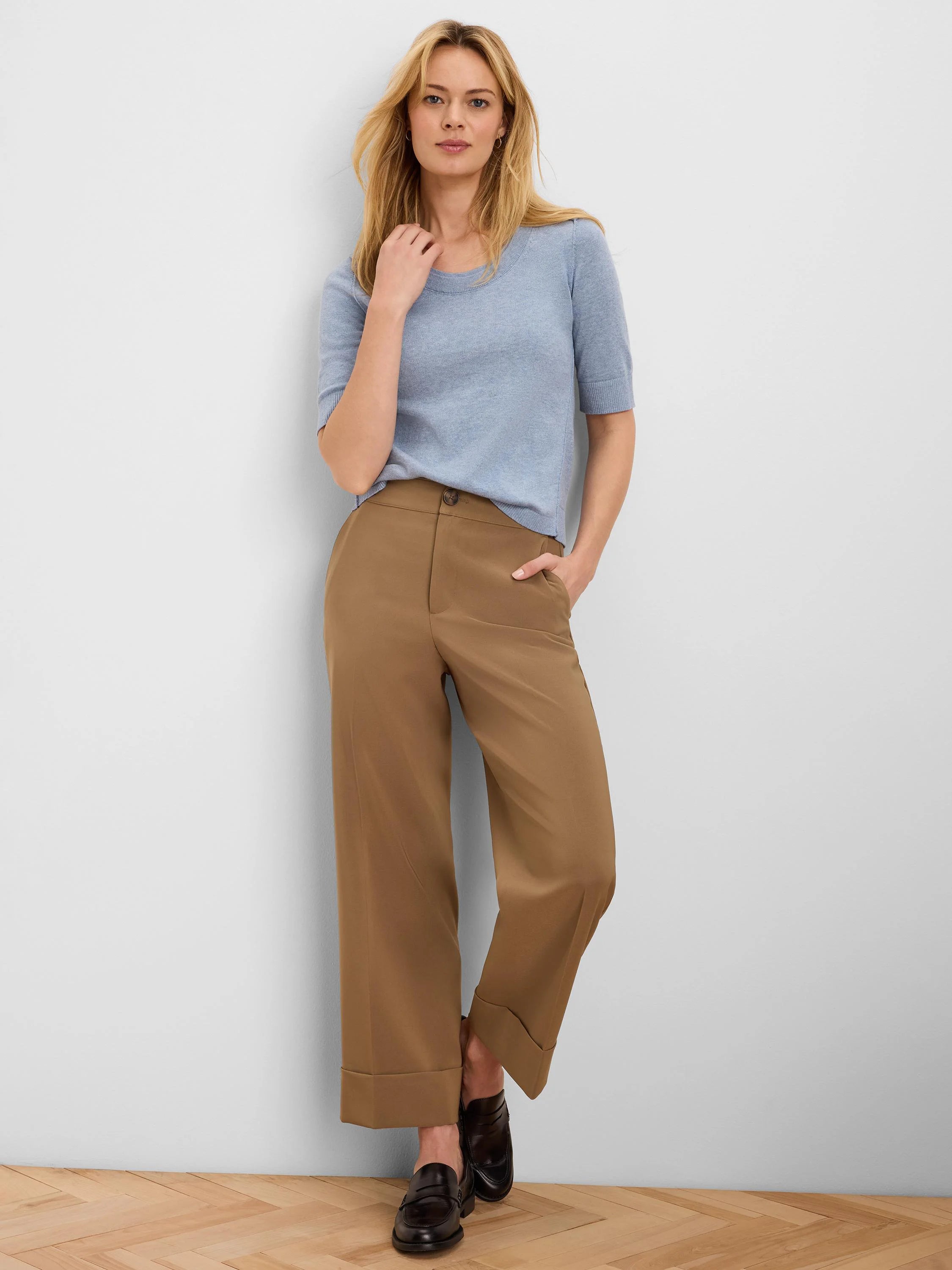 Pale blue, short-sleeved knit top with a rounded neckline.