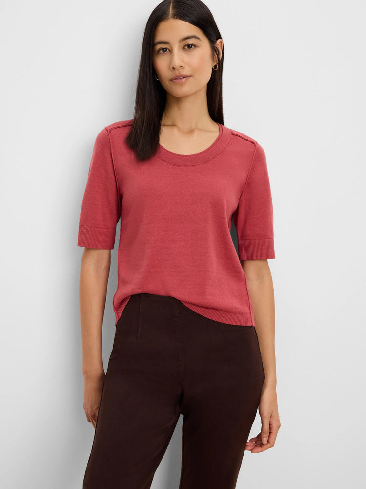 Terra cotta short-sleeve sweater tee with a crew neck, ribbed cuffs, hem, and subtle shoulder tabs, worn by a model.