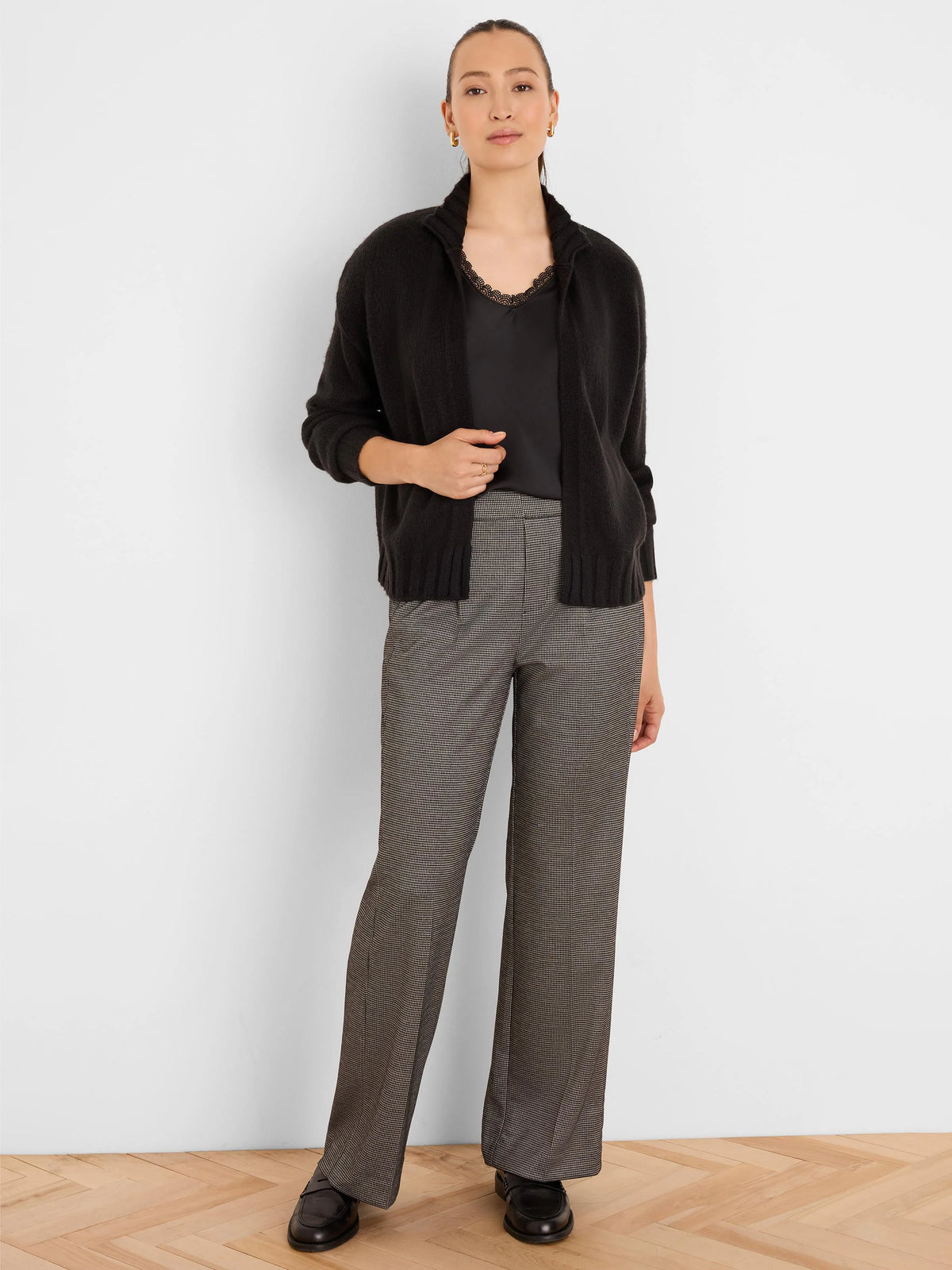 Black knit cardigan with a ribbed stand-up collar and open front, hip-length.
