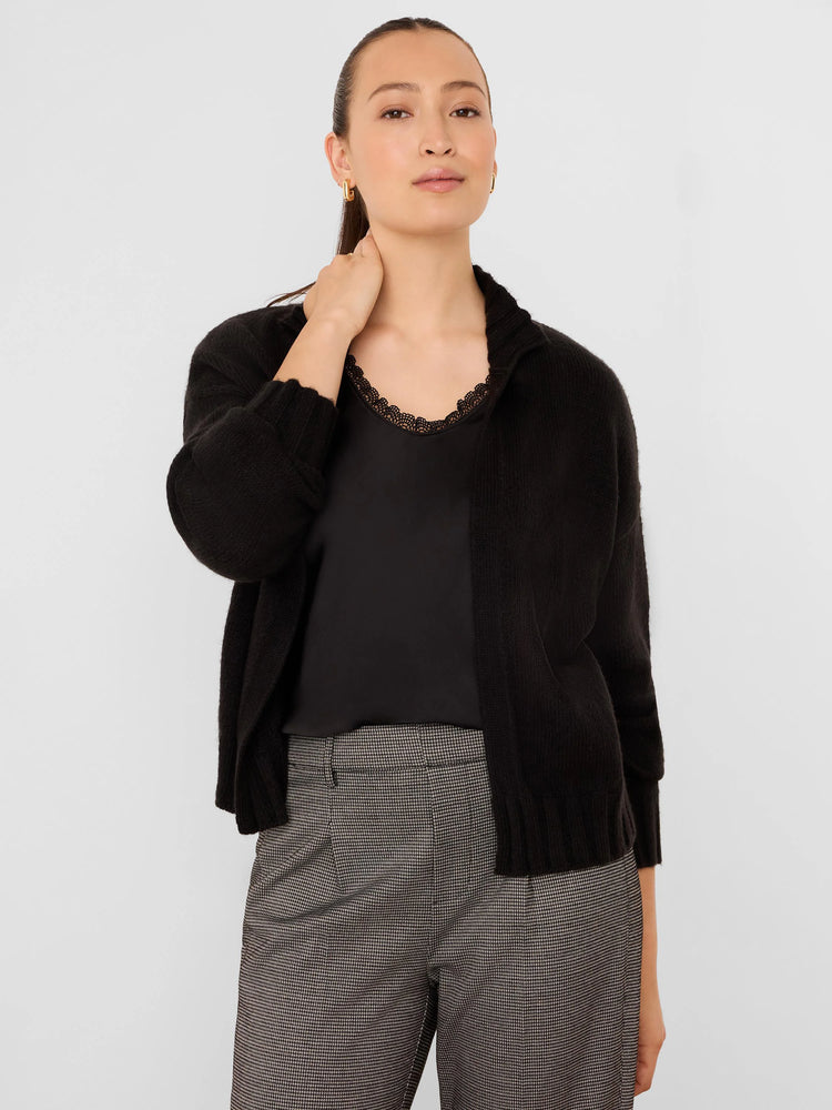 Black knit open-front cardigan with relaxed long sleeves and ribbed cuffs.