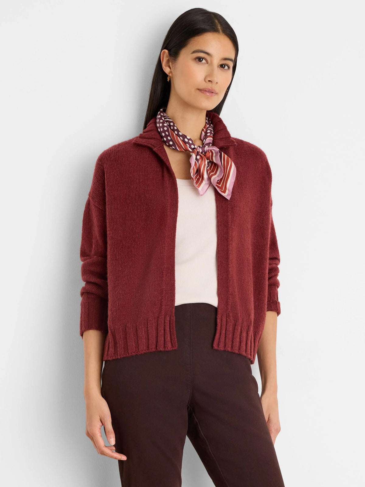 Burgundy knit cardigan, open front, with a ribbed collar, cuffs, and hem. Relaxed, hip-length fit.