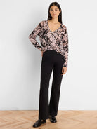 Cobbled Streets Sweater: Long-sleeved V-neck, black, light pink, and beige abstract pattern with subtle shimmer.