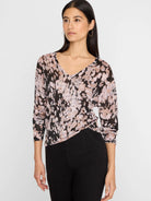 V-neck sweater with abstract pattern: black, mauve pink, and beige with a subtle shimmer. Features 3/4 sleeves.