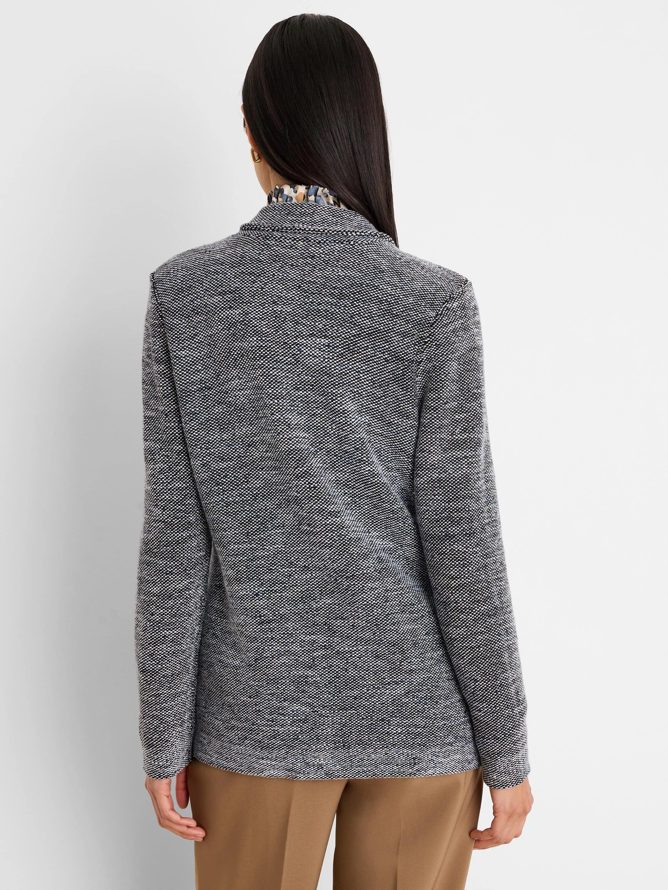 Black and white tweed stitch sweater jacket, back view. Fine weave with subtle blue flecks.
