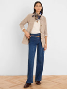 Speckled beige tweed stitch sweater jacket, collarless with buttoned front.