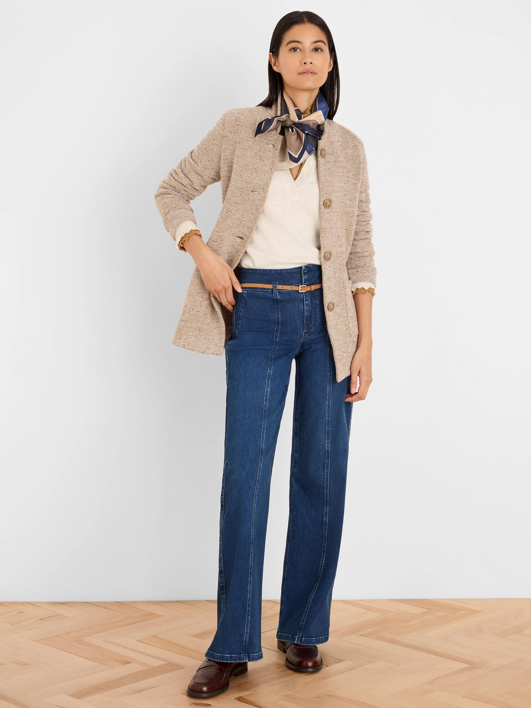 Speckled beige tweed stitch sweater jacket, collarless with buttoned front.