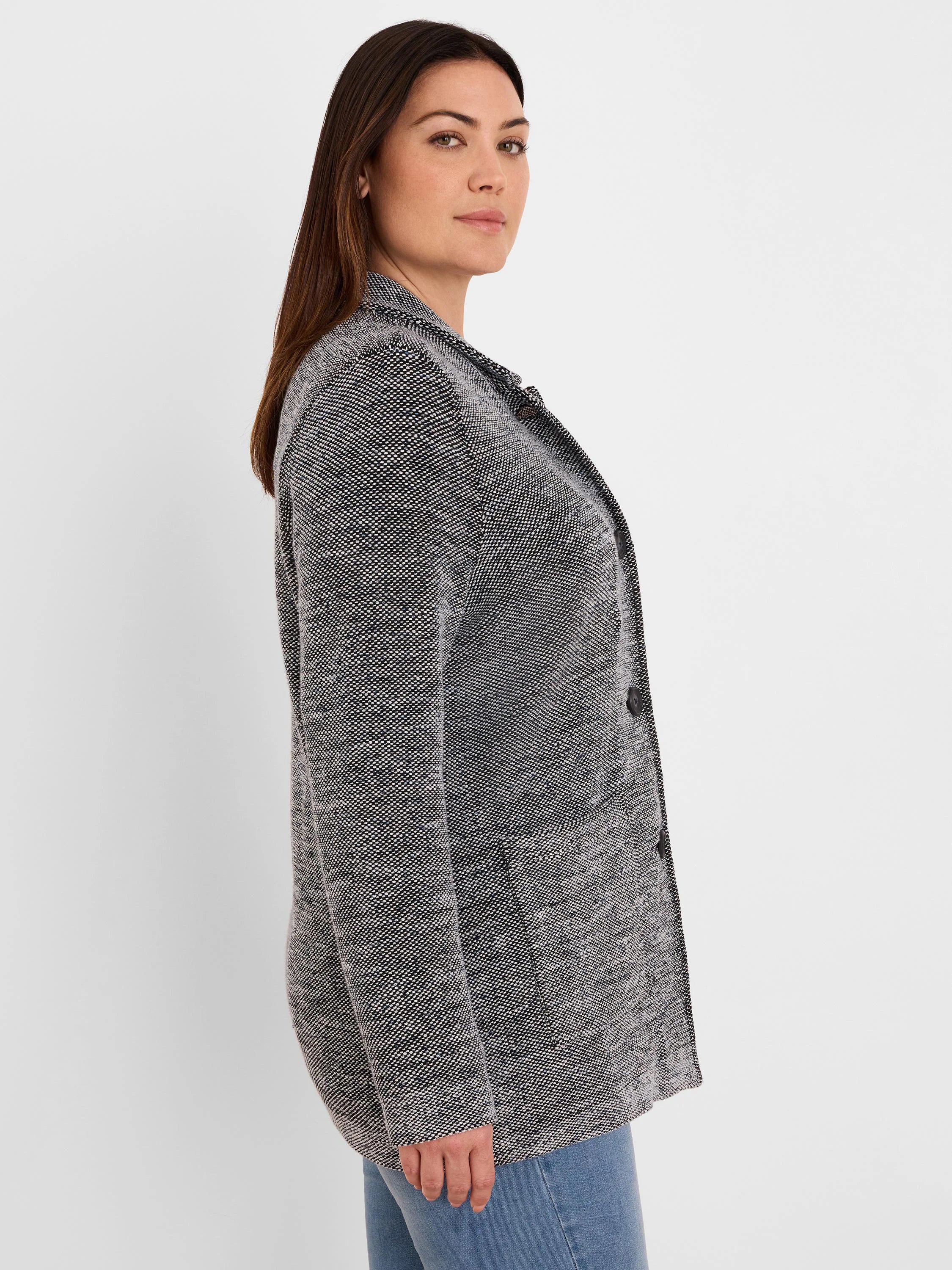 Black and white tweed stitch sweater jacket, open front, with two dark buttons and front patch pockets.