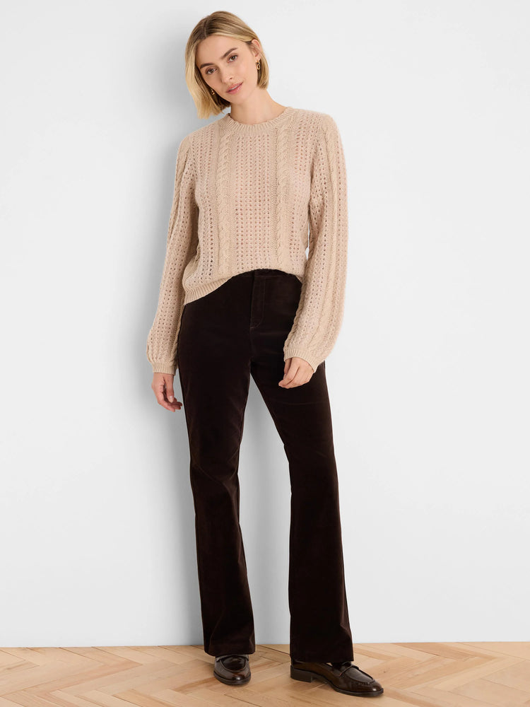 Light beige knit sweater with mixed cable and openwork patterns.