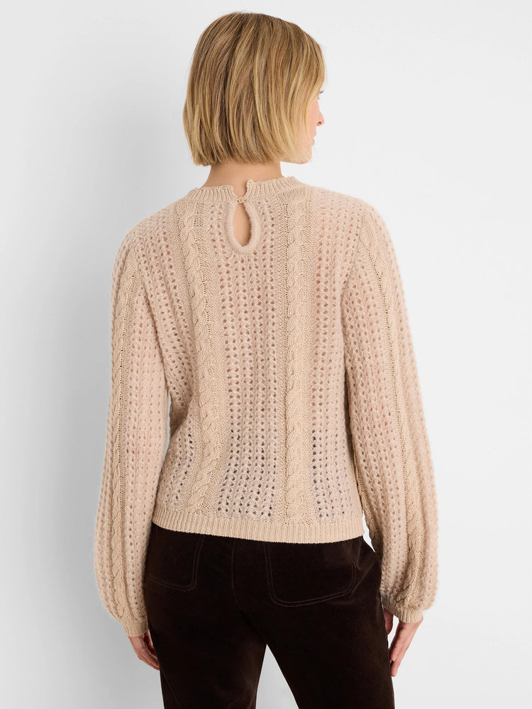 Light beige sweater, mixed cable and open-stitch knit, keyhole button at back neck.