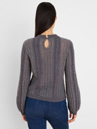 Grey sweater with mixed cable & openwork knits, keyhole button back, & puff sleeves.