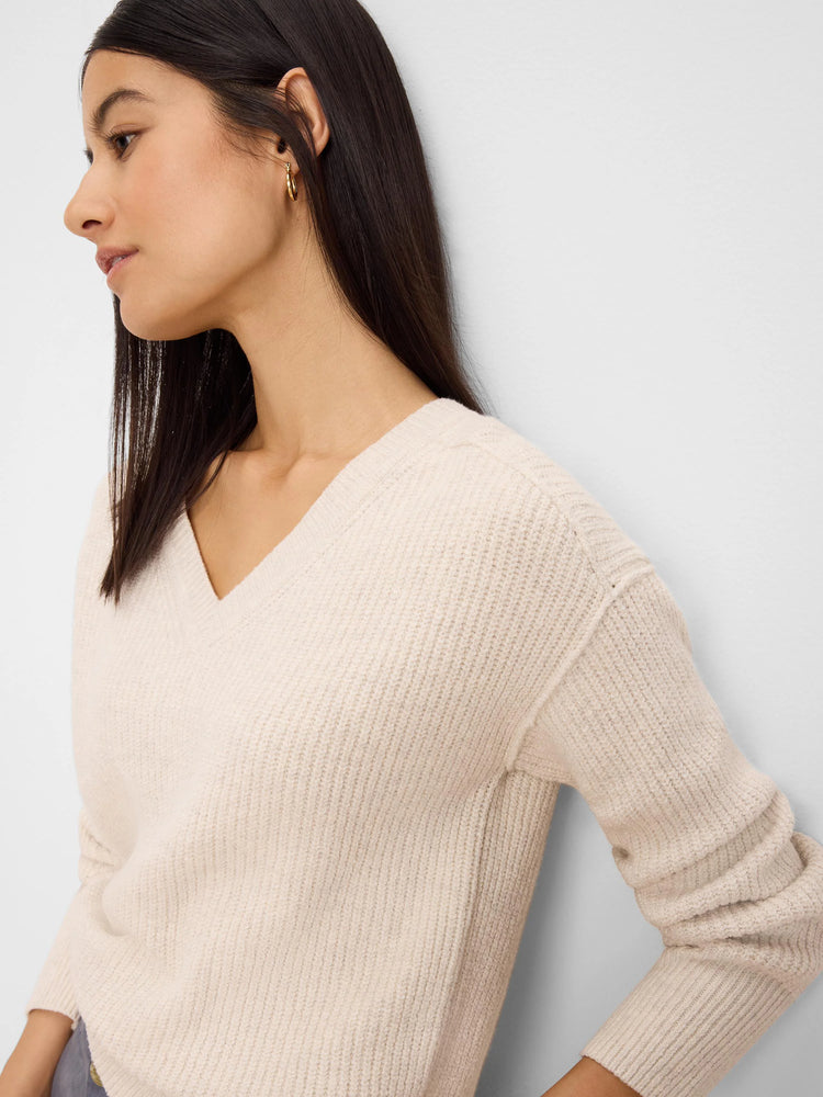 Oatmeal v-neck sweater with a thick ribbed knit texture.