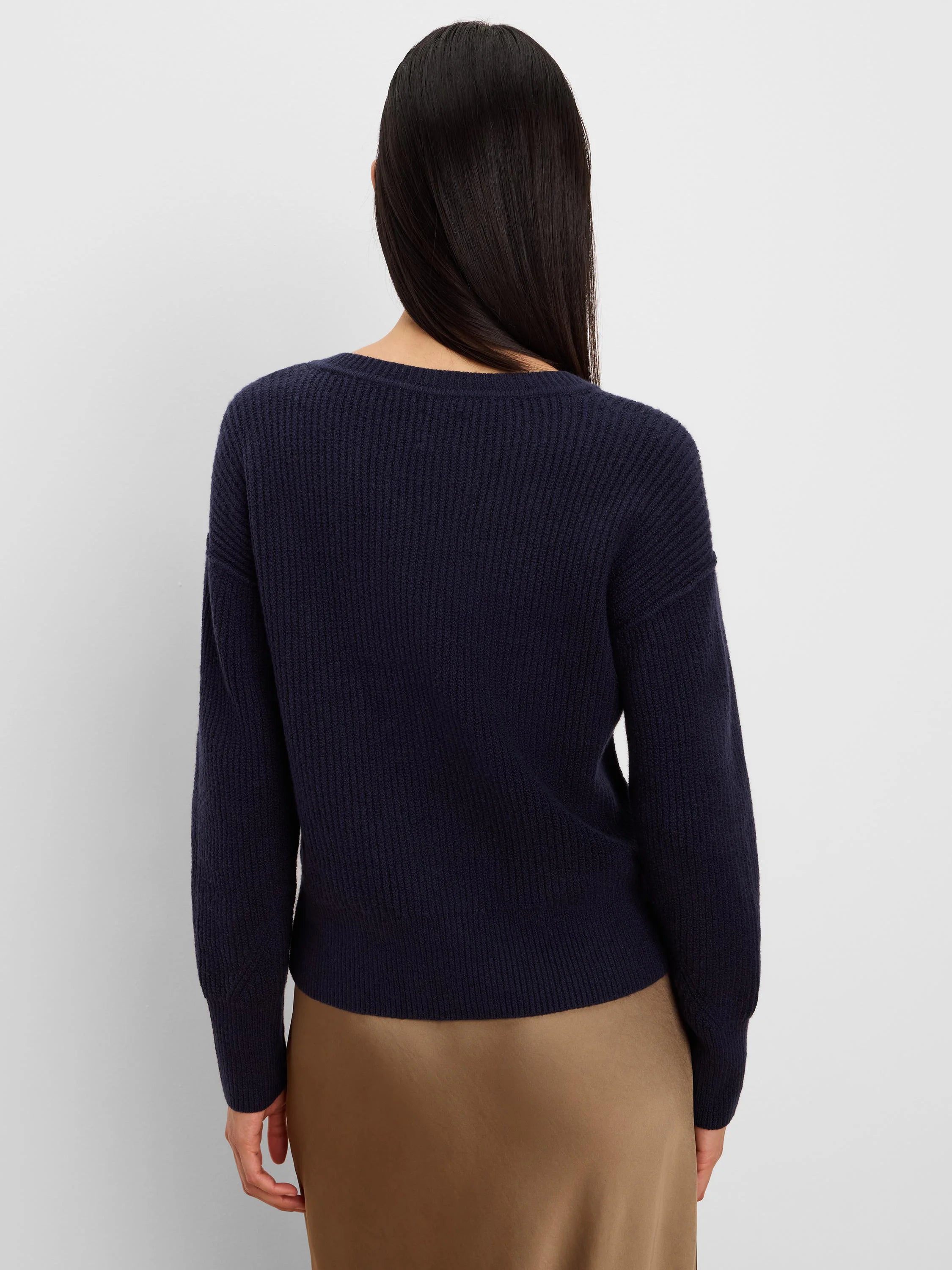 Navy blue ribbed knit sweater with crew neck and long sleeves, shown from the back.