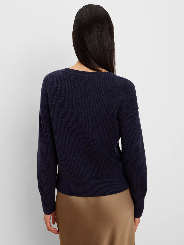 Navy blue ribbed knit sweater with crew neck and long sleeves, shown from the back.