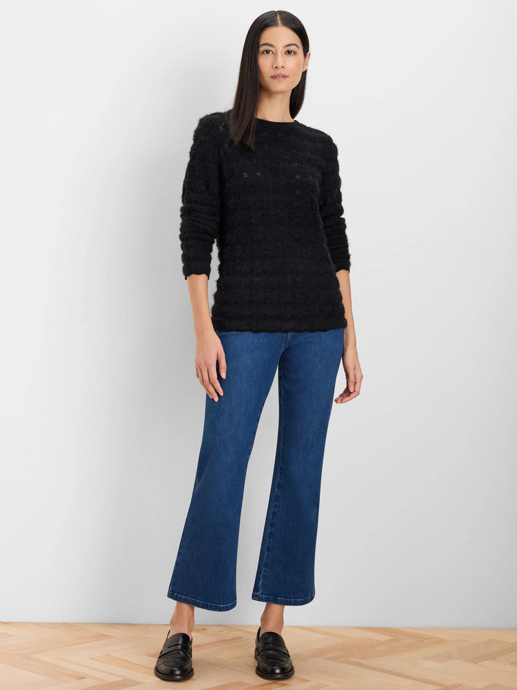 Black fuzzy crewneck sweater with scattered small openwork details along the upper chest and shoulders.