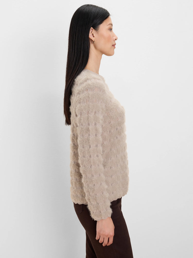 Light beige fuzzy knit sweater with an all-over openwork wave pattern.