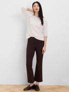 Off-white fuzzy sweater with a subtle wavy knit pattern.