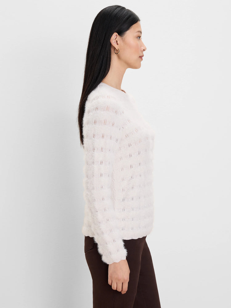 Off-white fuzzy sweater with a wavy openwork knit pattern.