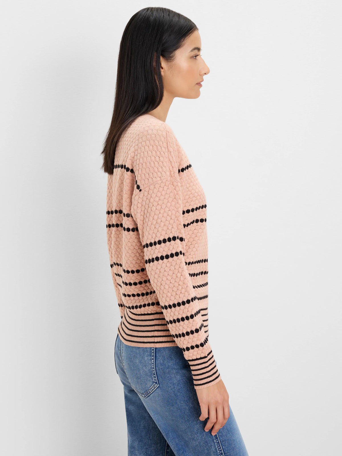 Blush pink textured sweater with black dotted horizontal stripes.