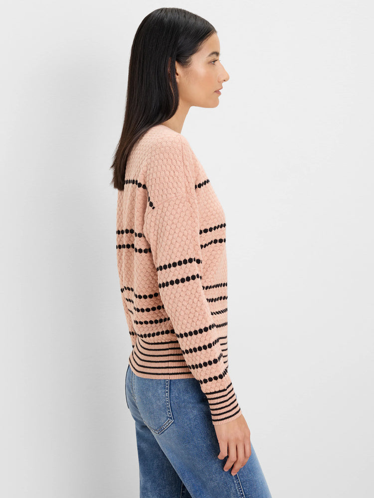 Blush pink textured sweater with black dotted horizontal stripes.