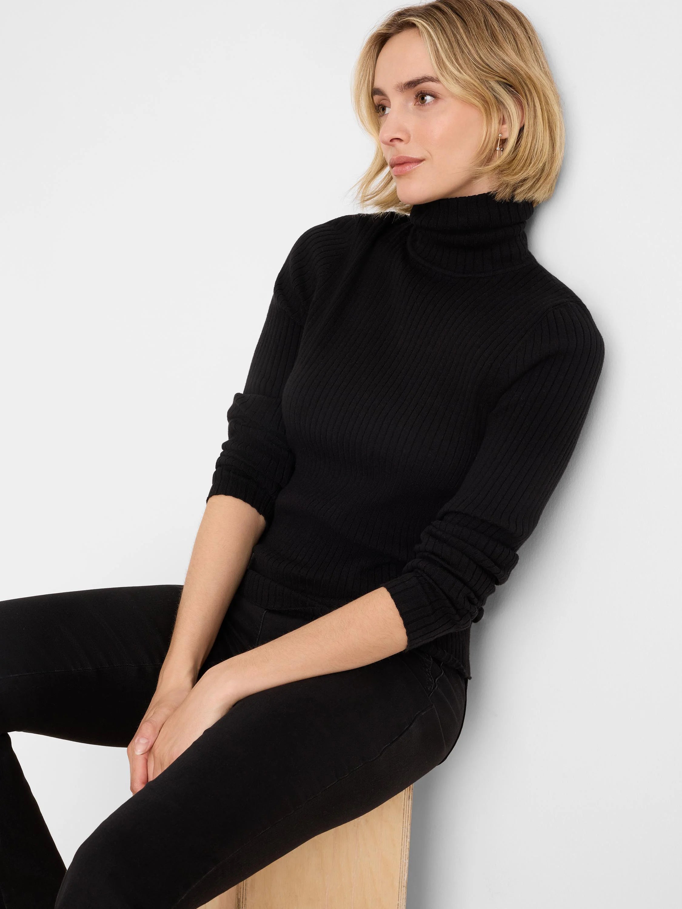 Black ribbed knit turtleneck with long sleeves.