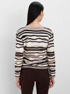 Fuzzy black, cream, and brown striped sweater with varied stripe widths.