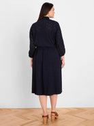 Dark blue eyelet dress, midi length, with a ruffled high neckline and elasticated waist.