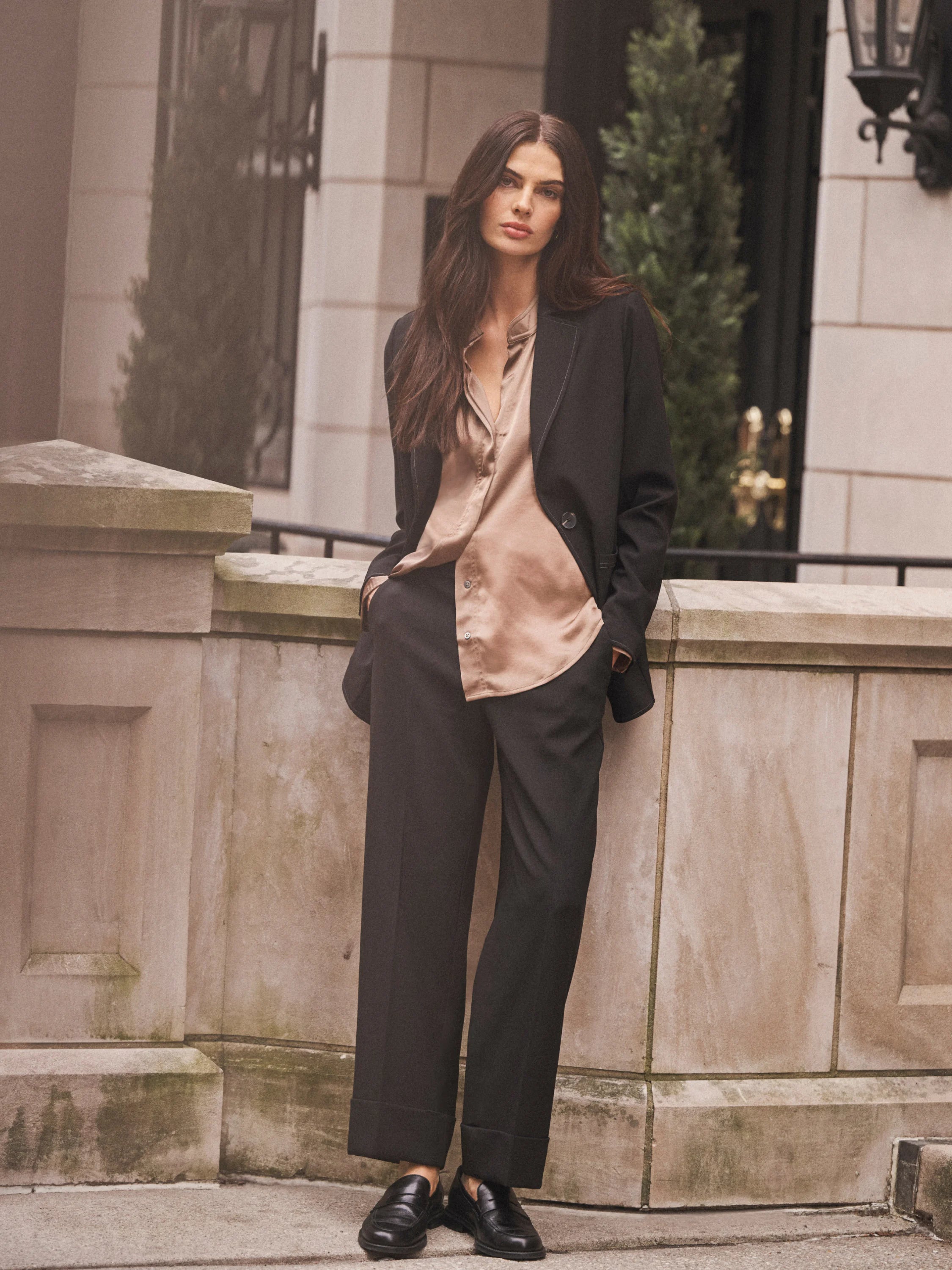 Black, straight-leg ankle pants with wide cuffs, worn by a model.