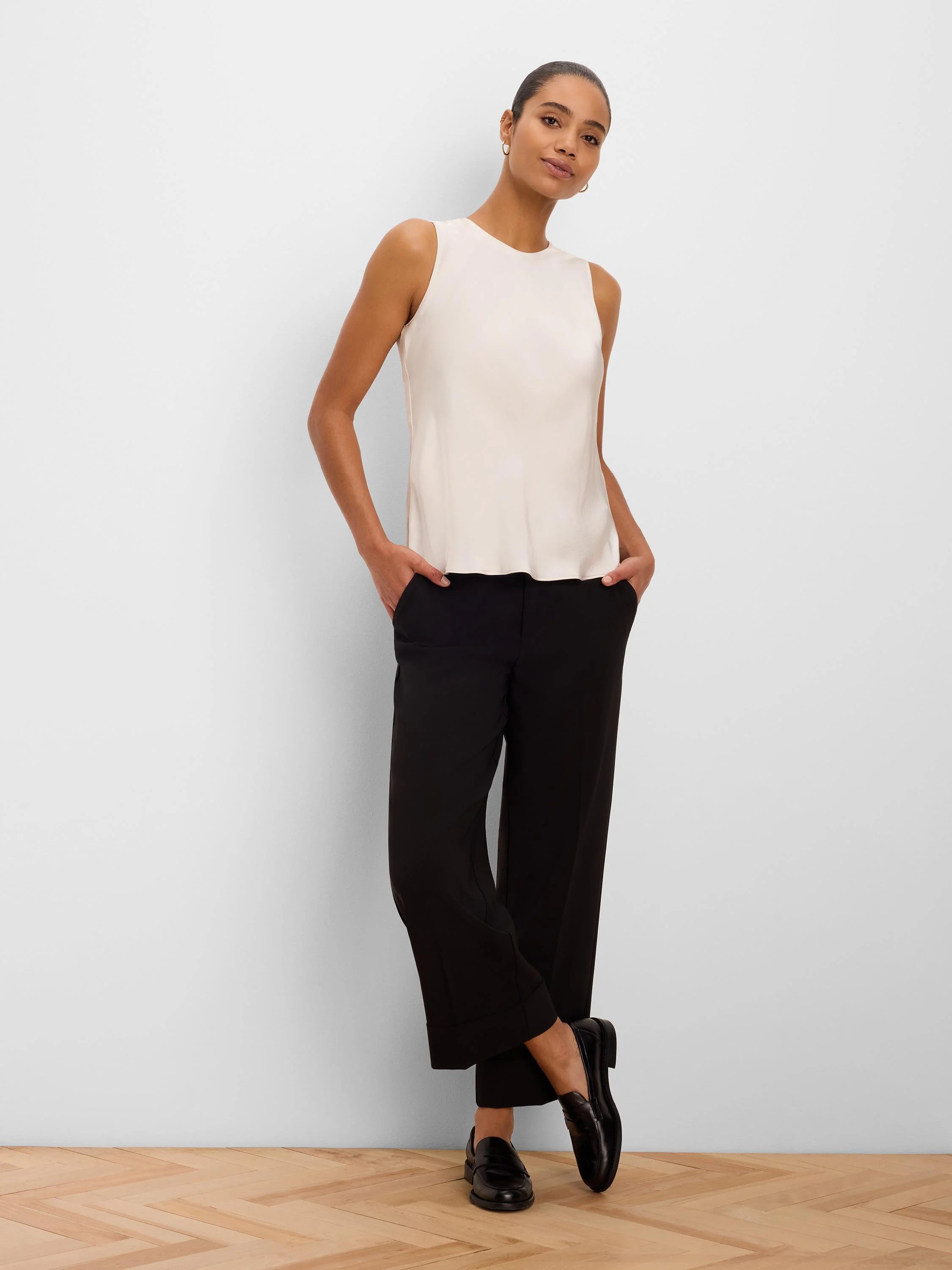 Black cuffed ankle pants with a straight-leg fit.