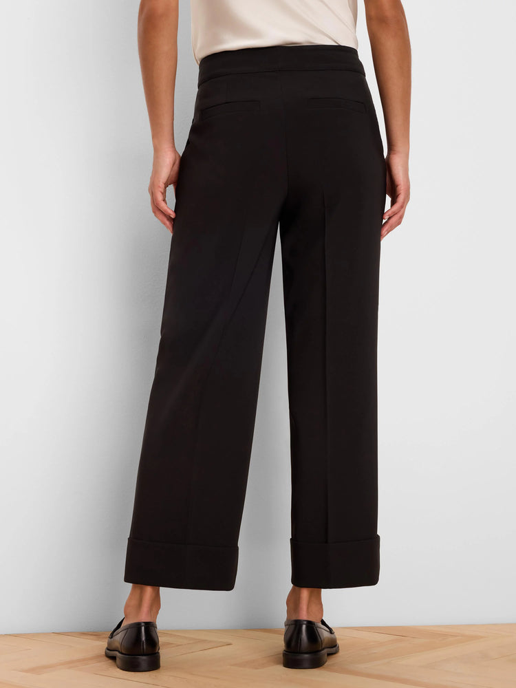 Black wide-leg ankle pants with cuffed hems and two back welt pockets, shown from the rear.