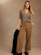 Camel wide-leg ankle pants with folded cuffs and a flat front, shown on a model.