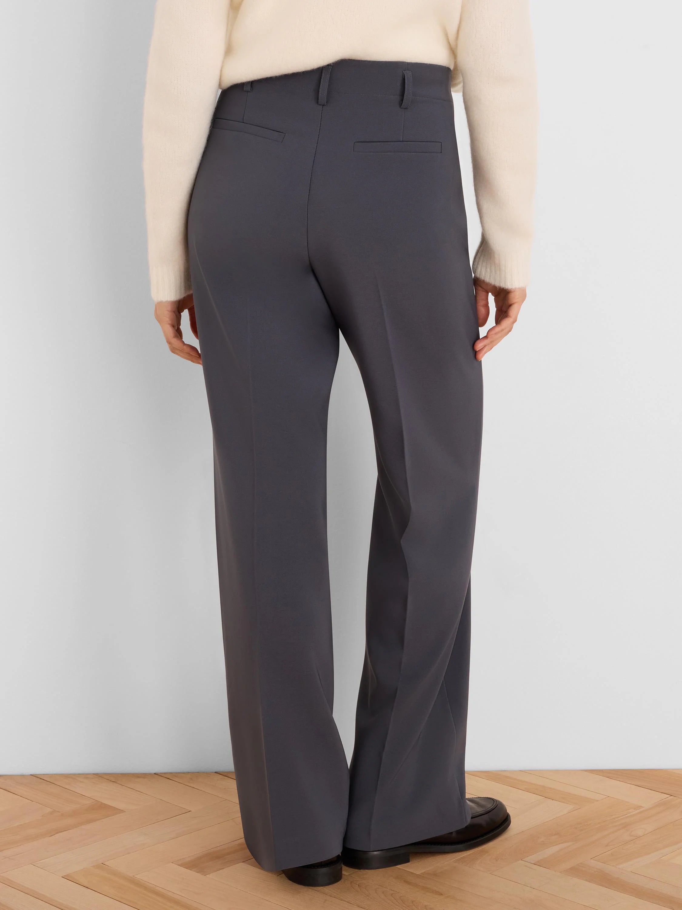 Dark gray wide-leg trousers, back view. Shows belt loops and two horizontal back pockets.