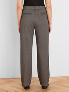 Brown and beige houndstooth tweed wide leg trousers, back view, with back welt pockets.