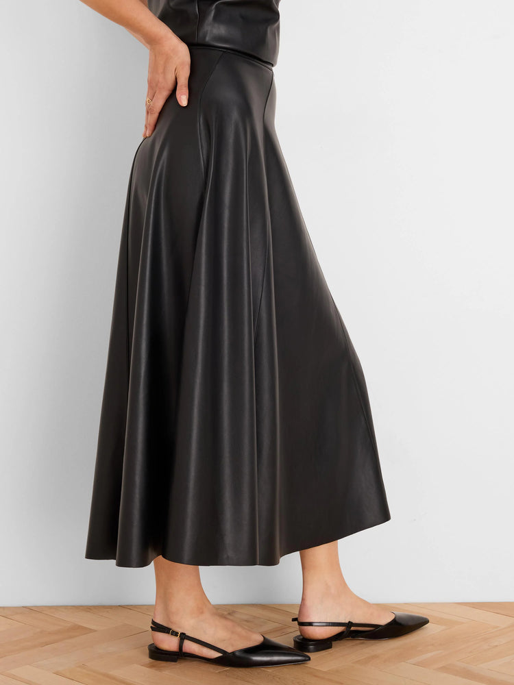 Black vegan leather seamed midi skirt with a flared silhouette.