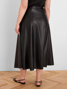 Black seamed vegan leather midi skirt with a flared A-line shape.