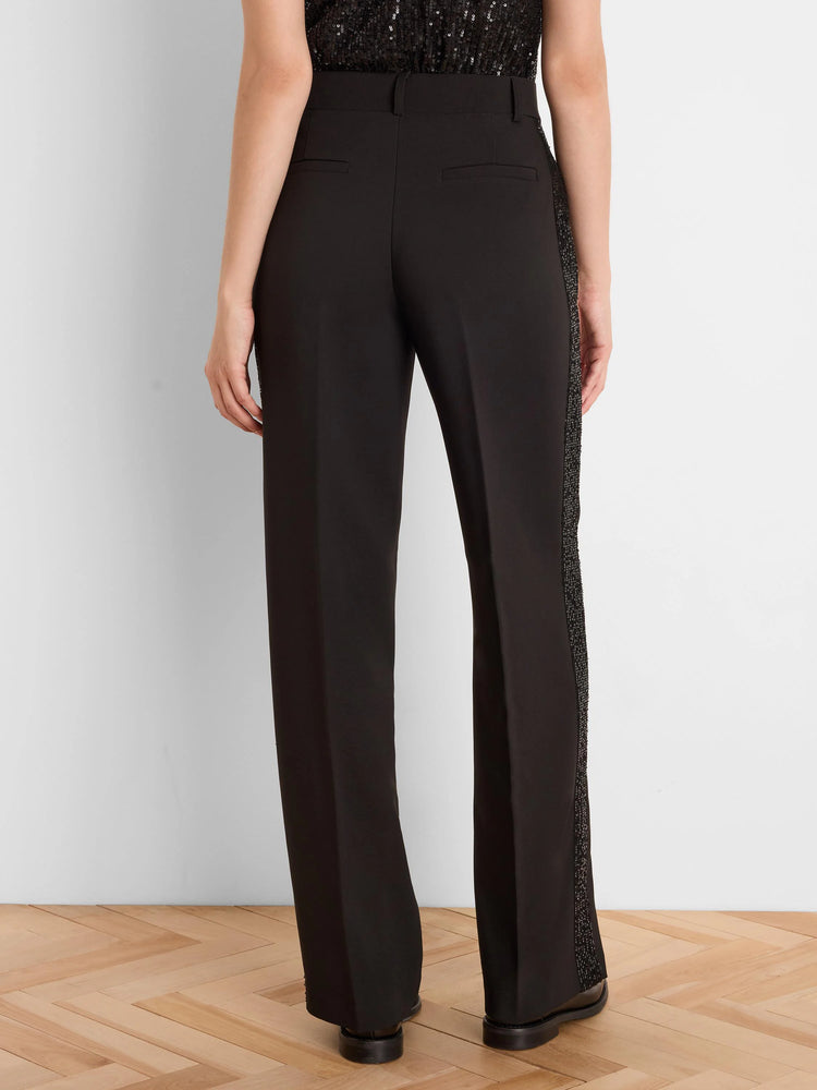 Black tuxedo pants with full-length sequin side stripes. Straight leg fit, shown from behind.
