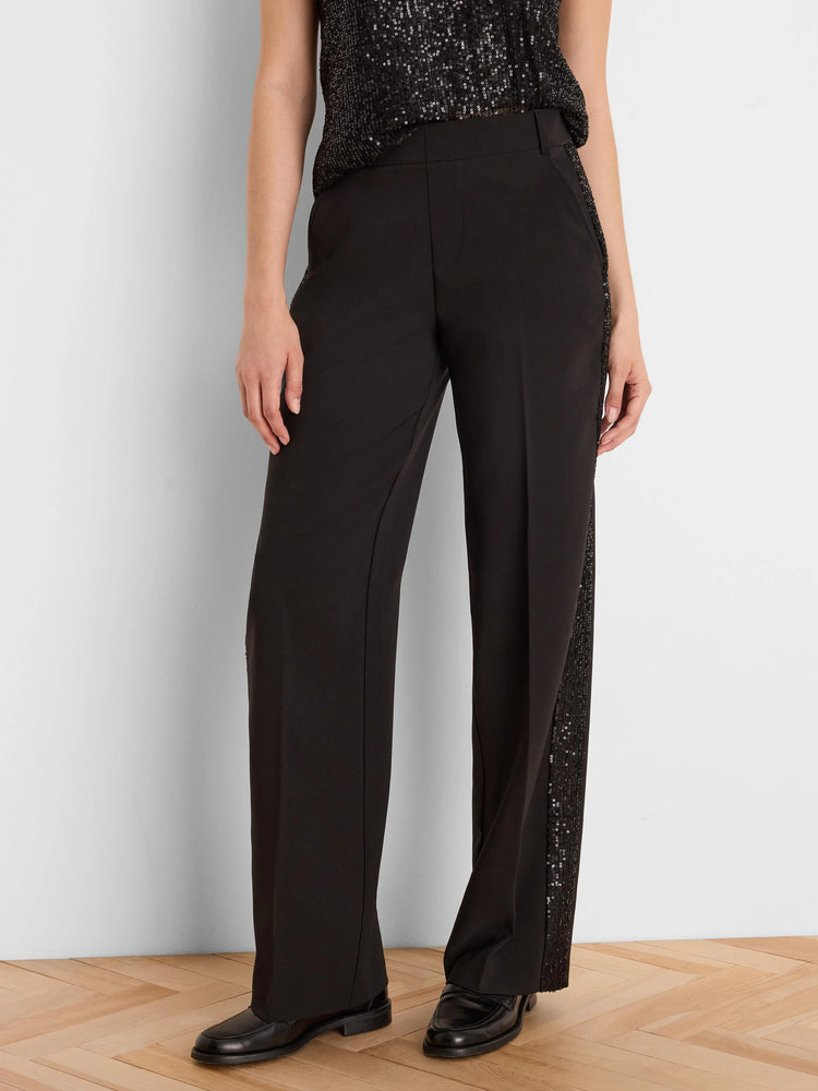 Black tuxedo pants with black sequin stripes on the outer seams.