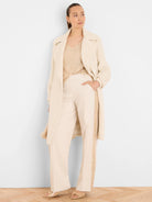 Off-white wide-leg pants with gold sequin tuxedo stripes along the side seams.