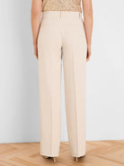 Back view of light beige wide-leg tuxedo pants with two horizontal back pockets and vertical sequin stripes.