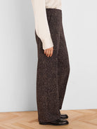 Dark brown wide-leg pants with a light brown speckled print, side pockets visible.