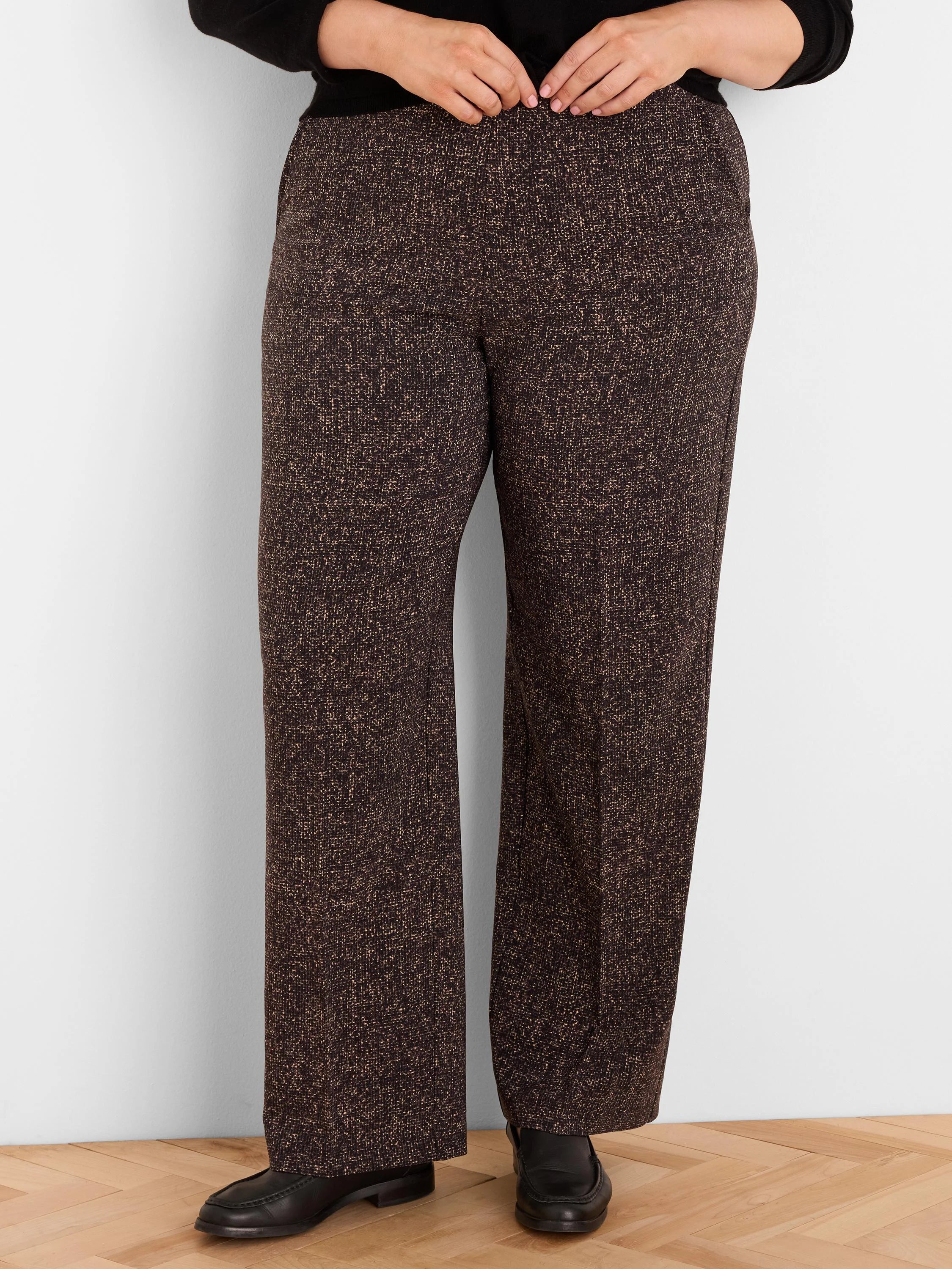 Dark brown wide-leg pants with a light speckled print, shown worn from the waist down.