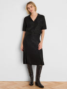 Black sequined knit midi skirt with a side slit.