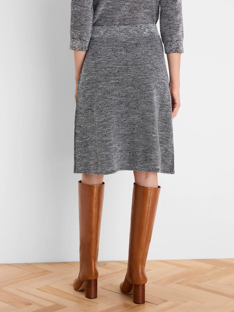Dark grey tweed stitch knit A-line skirt with white & blue flecks. Ribbed waistband & hem. Knee-length.