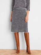 Grey tweed stitch knit skirt, knee-length, with ribbed waist and hem.