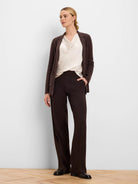 Dark brown, full-length wide-leg pants with a sleek, smooth texture.