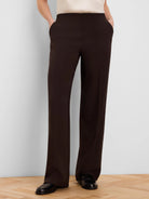 Dark brown wide-leg pants, full length. Features a smooth, flat waistband, subtle side pockets, and a clean drape.